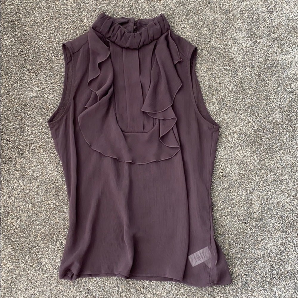 Sleeveless, ruffle front blouse.